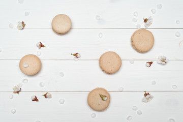 Macaroon cookies on a white wooden background