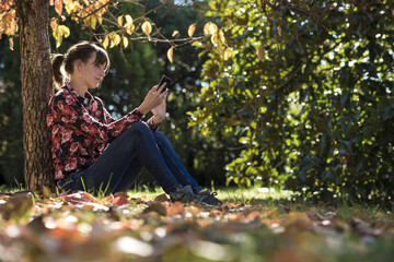 Young woman reading something on a digital device
