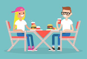 Restaurant visitors. Two teenagers having dinner in a fast food restaurant / flat editable vector illustration, clip art