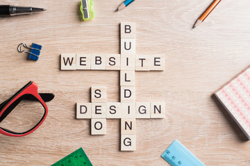 Conceptual media keywords on table with elements of game making crossword