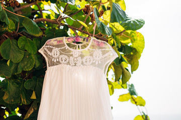 The bride's dress on a hanger in the green in Montenegro