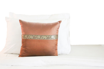 Pillows and bed on white background