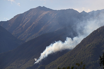 Fire fighting efforts are under way with helicopters to put out forest fires above Gordola, Ticino, Switzerland, on April 19th, 2017