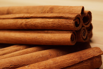 Cinnamon on wooden background