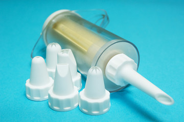 Naklejka premium Set of cream piping nozzles and cream injector (cooking bag) on blue background.