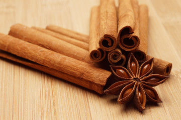 Anise and cinnamon on wooden background