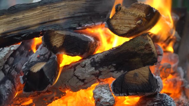 Coals burn in the grill. Handheld shooting