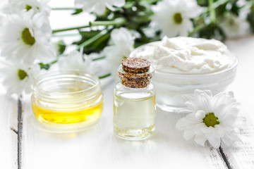 close up body care camomile cosmetic products on white wooden desk background