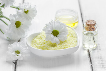 natural essential aroma oil with camomile on wooden table background