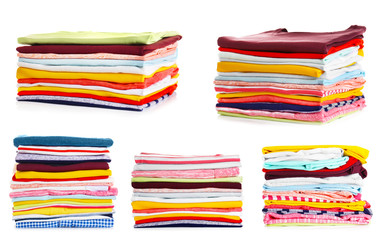Stacks of folded clothes on white background