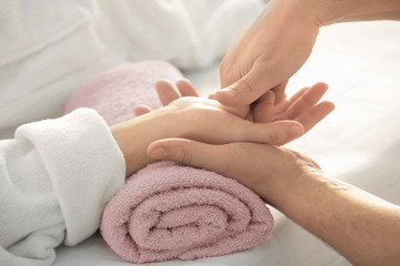 Young woman receiving hand massage in spa salon