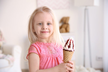 Cute little girl eating ice cream at home