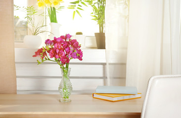 Vase with beautiful flowers on table