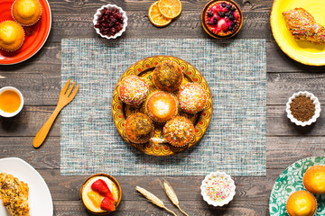 Delicious homemade muffins with yogurt, on a wooden background with space for text.