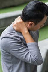 asian man suffering from neck pain, arthritis, gout symptoms