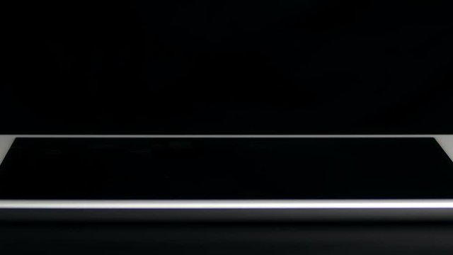 Man types text message on electronic tablet. Hands close-up.