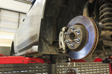 closeup repair disc brakes of car with soft-focus in the background. over light