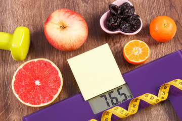 Electronic bathroom scale, centimeter, healthy food, dumbbells for fitness, slimming and healthy lifestyles concept