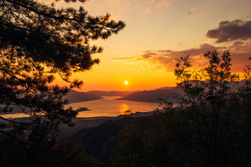 Fototapeta na wymiar Sunset in Montenegro over the mountains and the sea. Orange sunsets.