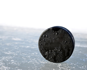 Hockey puck on a ice rink.