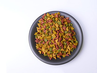 food for cats and dogs in black bowl on white.