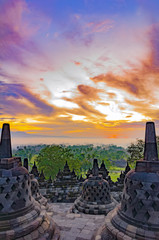 Fabulously beautiful clouds over the ancient temple complex Borobudur in Indonesia - obrazy, fototapety, plakaty