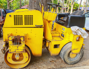 Road roller at road construction site with sunset