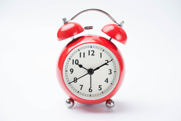 close up of a vintage red bell clock on white background