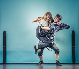 Fototapeta na wymiar couple of young man and woman dancing hip-hop