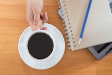 Fototapeta na wymiar Hot Cup Of Coffee On Working Table