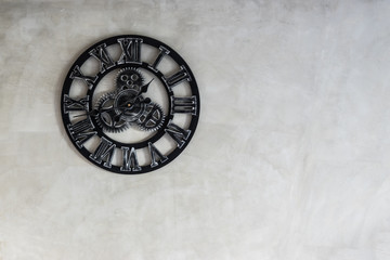 Classic clock on raw concrete wall background