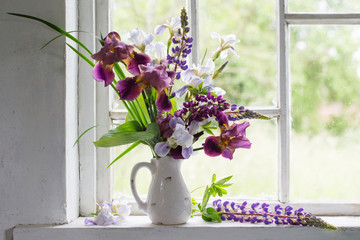 Flower vase sitting inside of window