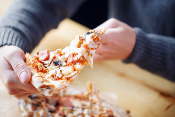 one people taking slices of pizza. fast delivery of food. packaging for fast food. top view