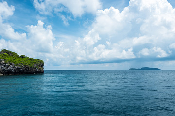 Seascape and small island with blue sky