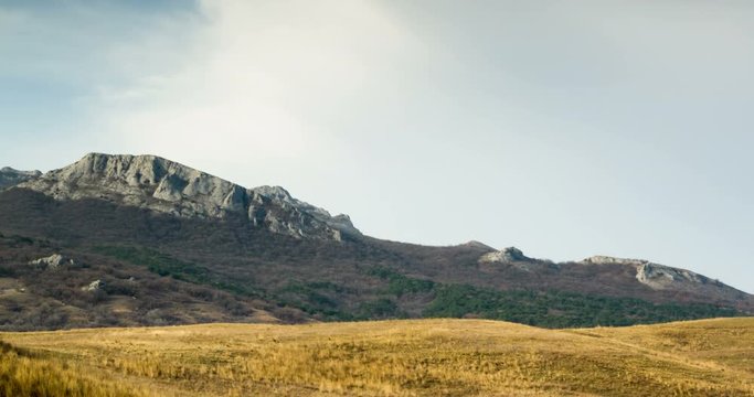 rain clouds over the valley with dry ellow grass.