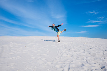 Adventurer having fun among the sand dunes in a wilderness