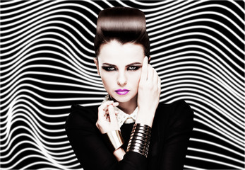 Fashion portrait of young caucasian model with bright makeup on striped black and white background....