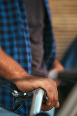 Crop male hand on handlebar