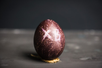 Colored easter egg on the dark background. Shallow depth of field.