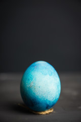 Colored easter egg on the dark background. Shallow depth of field.