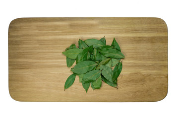 A hill of laurel sheets of rash on an isolated cutting board.