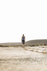 Woman in Sportswear Fitness Walking in Desert