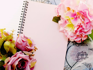 blank notebook with bouquet of flower vintage filters background