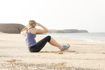 Woman Doing Torso Stretches by the Seaside