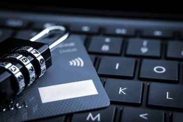 Internet payments, secure online shopping and data encryption security concept with passcode combination padlock and credit card on computer keyboard, closeup with copy space and selective focus