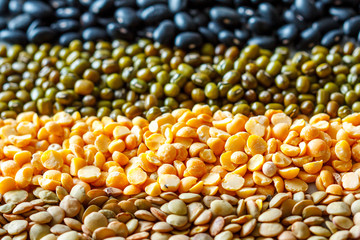 Cereals background: chickpeas, peas, lentils, black beans