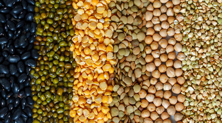 Cereals background: chickpeas, peas, lentils, green buckwheat, black beans, sesame seeds.