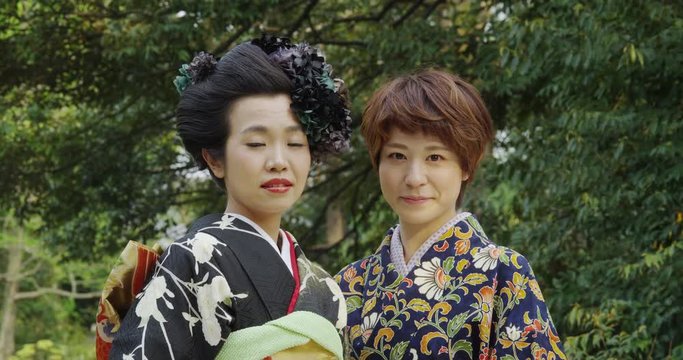 2 Japanese Women in Kimono in the Park of a Shrine