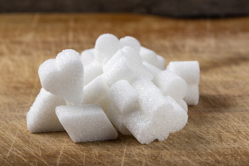 Different sugar shapes of cubes on wood