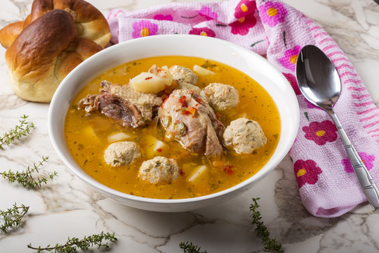 Meat balls soup with spoon and bread